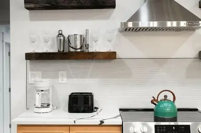 a kitchen with a counter with glasses on the wall at Summit Woods Hideaway Cozy Pocono Getaway in Pocono Summit