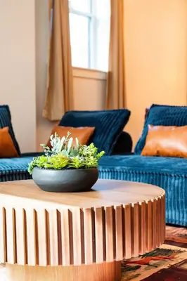a living room with a table with a plant on it at Pocono Summit Lodge Game Room & Family Fun in Pocono Summit