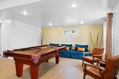 a living room with a pool table and a couch at The Grand Pocono Getaway Waterparks & Raceway in Pocono Summit