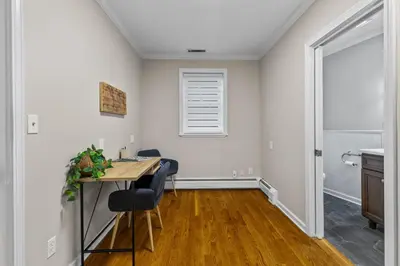 a dining room with a table and a window at New England Nest - Modern 2BR Home with EV Charger in Shelton