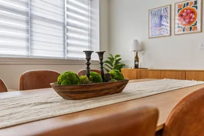 a bowl of water melons on a wooden table at New England Nest - Modern 2BR Home with EV Charger in Shelton