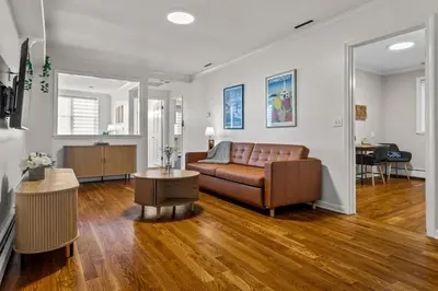 a living room with a couch and a table at New England Nest - Modern 2BR Home with EV Charger in Shelton