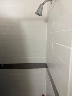 a bathroom with a shower with a light on it at Inner City Charm in New York