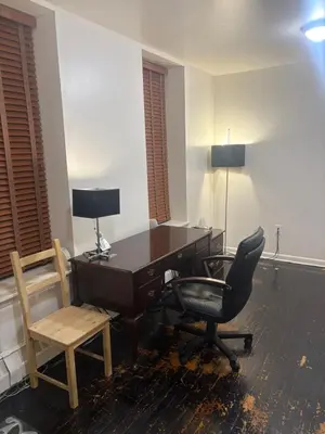 an office with a desk and a chair at Inner City Charm in New York