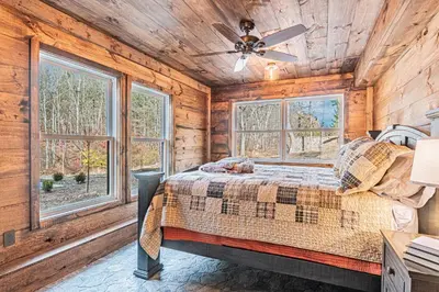 a bedroom with a bed and a ceiling fan at Modern Barn with Hot Tub, Game Room & Sleeps 14 in High Falls
