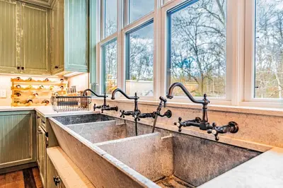 a kitchen with a large sink and windows at Modern Barn with Hot Tub, Game Room & Sleeps 14 in High Falls