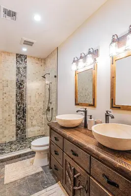 a bathroom with two sinks and a shower at Modern Barn with Hot Tub, Game Room & Sleeps 14 in High Falls