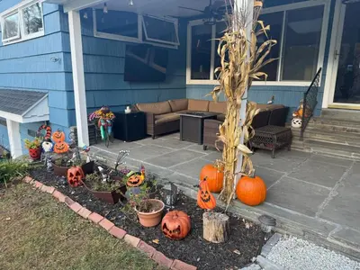 a yard with pumpkins and a porch with a house at Sunset Over The Junction in Roscoe