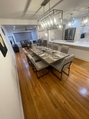 a dining room and kitchen with a table and chairs at Modern Glam Getaway 30 minutes from NYC in West Orange