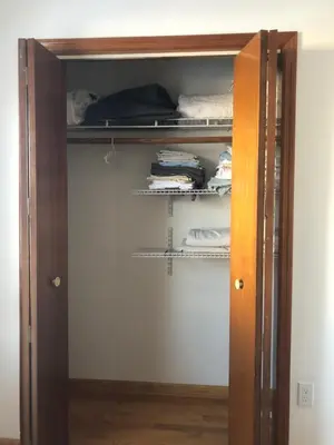 a closet with an open door with towels at Comfort house with two bed room in Greenwich