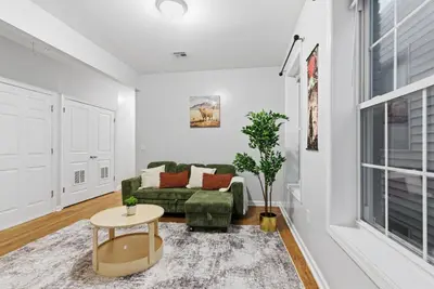 a living room with a couch and a table at Cozy 2BR Apartment in Jersey City with Smart Lock in Croxton