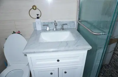 a bathroom with a sink and a toilet and a shower at New York Private Room 32 in West New York