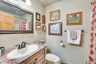 a bathroom with a sink and a toilet and a mirror at Beautiful and Unique Farmhouse 15 Mi to Saratoga in Argyle