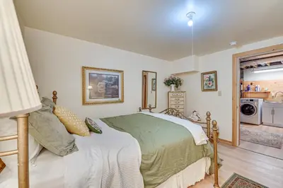 a bedroom with a bed and a kitchen at Beautiful and Unique Farmhouse 15 Mi to Saratoga in Argyle