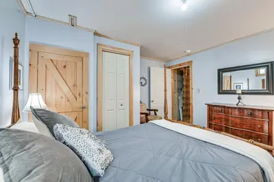 a bedroom with a bed and a wooden dresser at Beautiful and Unique Farmhouse 15 Mi to Saratoga in Argyle