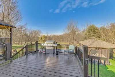 a wooden deck with a grill and a gazebo at Beautiful and Unique Farmhouse 15 Mi to Saratoga in Argyle