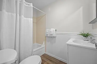 a white bathroom with a toilet and a sink at Cozy Mountain Retreat 3 Min to Hunter Mountain in Hunter