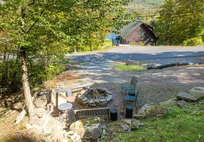a fire pit with a table and chairs and a barn at Cozy Mountain Retreat 3 Min to Hunter Mountain in Hunter