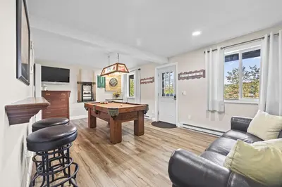 a living room with a ping pong table and a couch at Cozy Mountain Retreat 3 Min to Hunter Mountain in Hunter