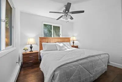 a bedroom with a bed and a ceiling fan at Cozy Mountain Retreat 3 Min to Hunter Mountain in Hunter