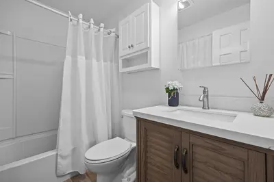 a white bathroom with a toilet and a sink at Cozy Mountain Retreat 3 Min to Hunter Mountain in Hunter