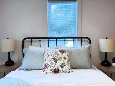 a bedroom with a bed with pillows and two lamps at Kenoza Lake Waters wLake AccessCanoeIce-fish in Callicoon