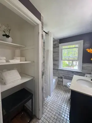 a bathroom with a shower and a sink and a tub at Pet Friendly 3BR New Britain Home with King Bed Near Hartford Sleeps 8 in New Britain
