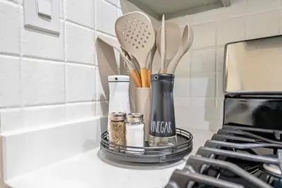 a kitchen counter with a rack with utensils on it at Near to Manhattan PATH Train To NYC EWR in Harrison