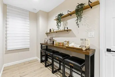 a kitchen with a bar with black stools at Near to Manhattan PATH Train To NYC EWR in Harrison
