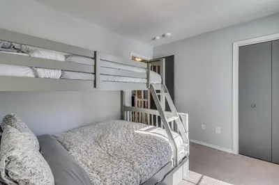 a bedroom with two bunk beds and a ladder at Family Retreat with Game Room, 4 Mi to Kalahari! in Emerald Lakes