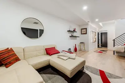 a living room with a white couch and a mirror at Modern Lakeview Home with Private Dock Sleeps 5 in Landing