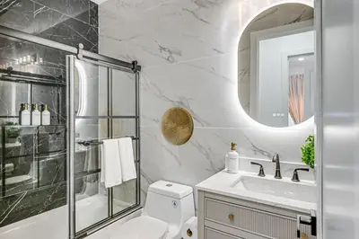 a bathroom with a toilet and a shower and a sink at 6 Mi to Manhattan Luxe Apt with City Views! in Jersey City