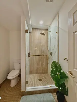 a bathroom with a shower with a toilet at Spring Rooms by Yale & Downtown in New Haven