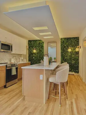 a large kitchen with a counter and chairs in it at Spring Rooms by Yale & Downtown in New Haven