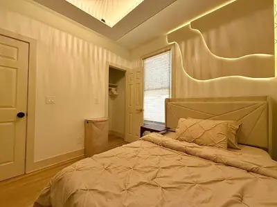 a bedroom with a large bed with a large headboard at Spring Rooms by Yale & Downtown in New Haven