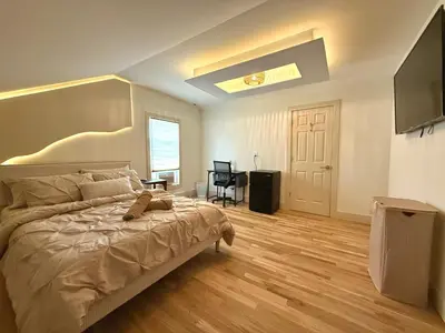 a bedroom with a bed and a television in it at Spring Rooms by Yale & Downtown in New Haven
