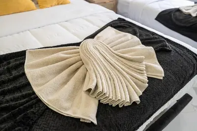 a pair of towels sitting on top of a bed at 5 beds 7 person Prime Location Near Transit NYC in Jersey City