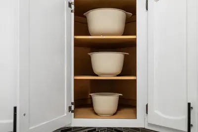 a cupboard with two white bowls in it at Bright 4B - Full Kitchen -15 min to Mannhatan in Jersey City