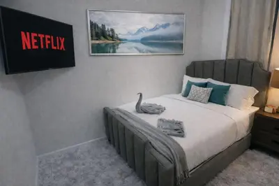 a bedroom with a bed with a swan on it at 3-Bedroom 5-Beds JC Downtown 19Minutes Time Square in Jersey City