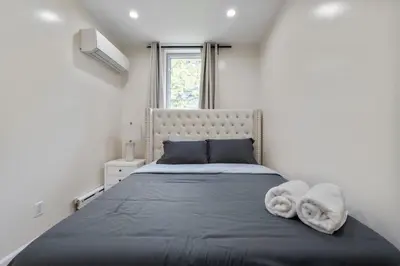 a bedroom with a large bed with towels on it at Spacious 3 Bed 3 Bath Unit in Upper East Side in New York