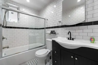 a bathroom with a sink and a toilet and a tub at Spacious 3 Bed 3 Bath Unit in Upper East Side in New York