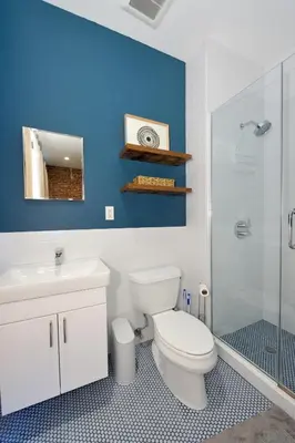 a bathroom with a toilet and a sink and a shower at Time Square Vicinity- Luxury 2BR 2BA NYC Apt in New York
