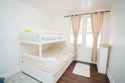a white bunk bed in a room with a window at Pet Friendly Jersey City Apartment Near NYC Sleeps 6 with Easy Manhattan Access in Jersey City