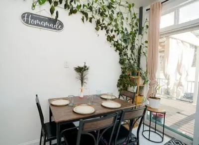 a dining room with a table and some plants at Pet Friendly Jersey City Apartment Near NYC Sleeps 6 with Easy Manhattan Access in Jersey City