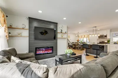 a living room with a couch and a fireplace at Easy Transit to NYC! Sleek North Shore Hideaway in Huntington Station