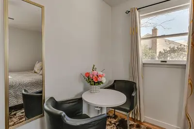 a room with a table and chairs and a mirror at Easy Transit to NYC! Sleek North Shore Hideaway in Huntington Station