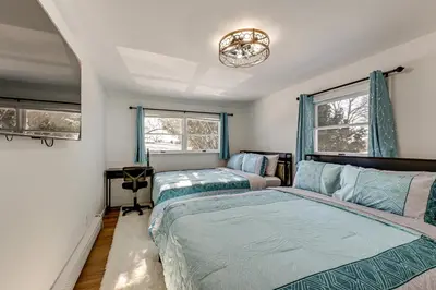a bedroom with two beds and a window at Easy Transit to NYC! Sleek North Shore Hideaway in Huntington Station