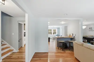 a kitchen and living room with white walls and a couch at Comfortable Bloomfield 3BR Retreat home in Bloomfield