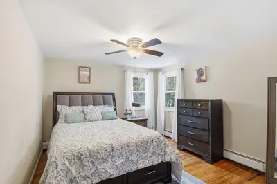 a bedroom with a bed and a ceiling fan at Comfortable Bloomfield 3BR Retreat home in Bloomfield
