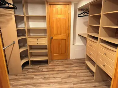 a walk in closet with a wooden door at Americana in Jersey City